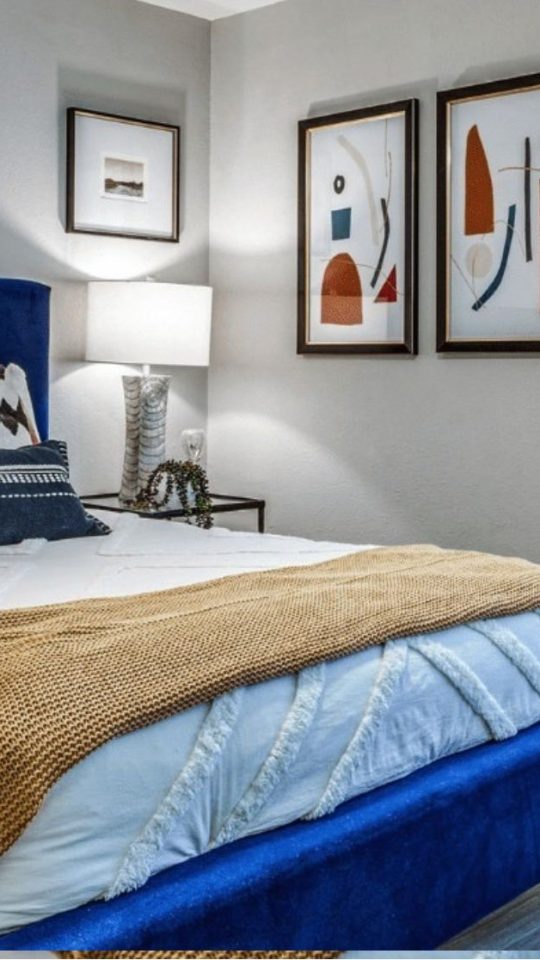 a bedroom with blue and red upholstered headboard at The Richmond
