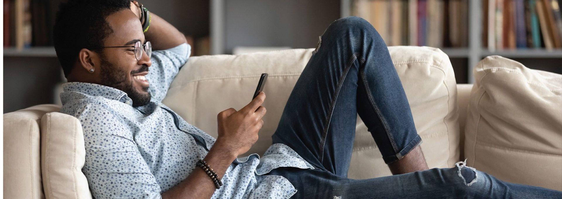 a man sitting on a couch with his feet up and his phone in his hand at The Richmond