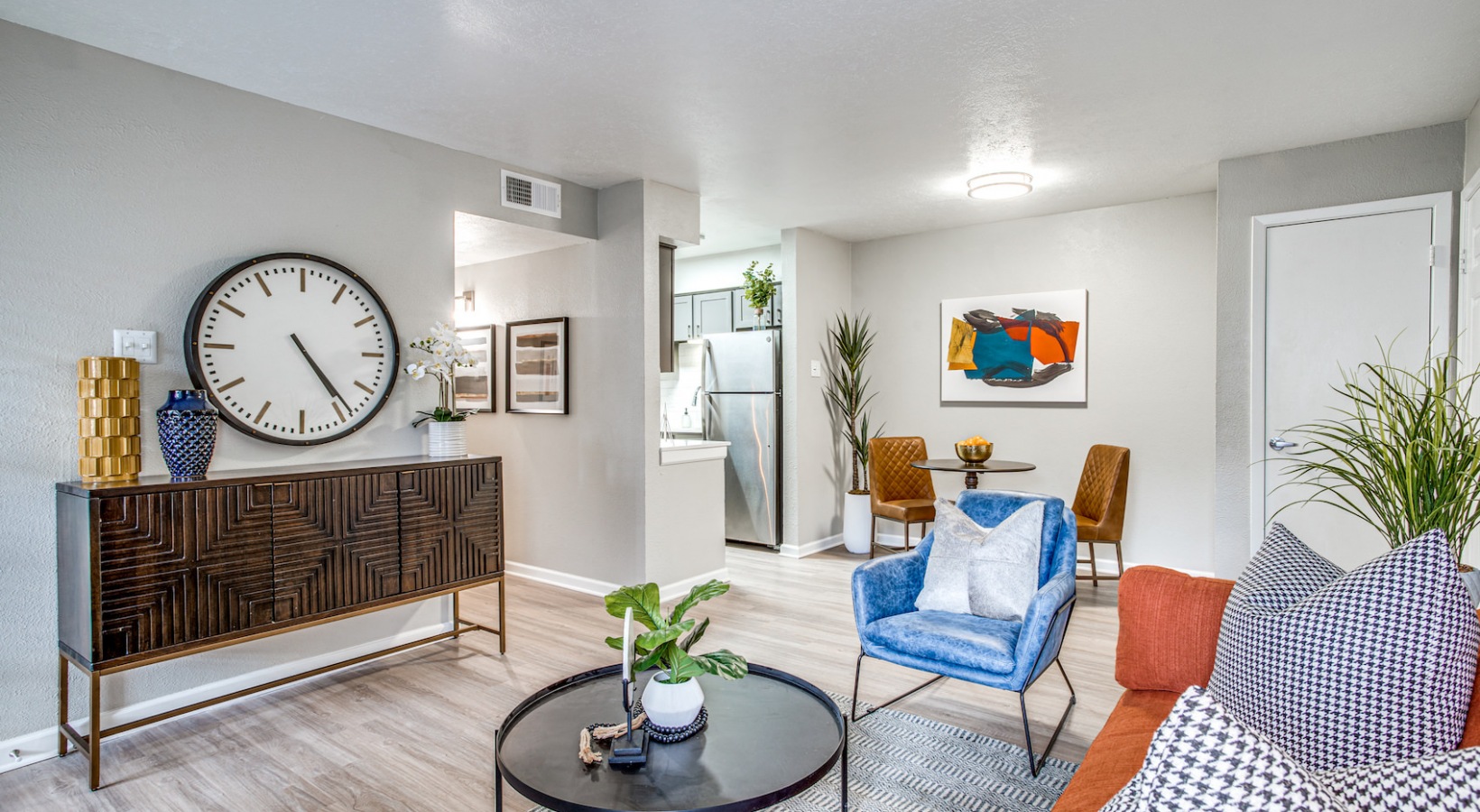 a living room with a blue couch, coffee table and a clock at The Richmond