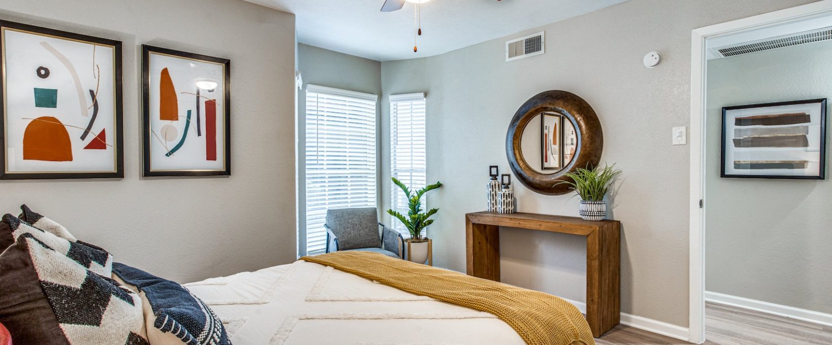 a bedroom with a bed, dresser and ceiling fan at The Richmond