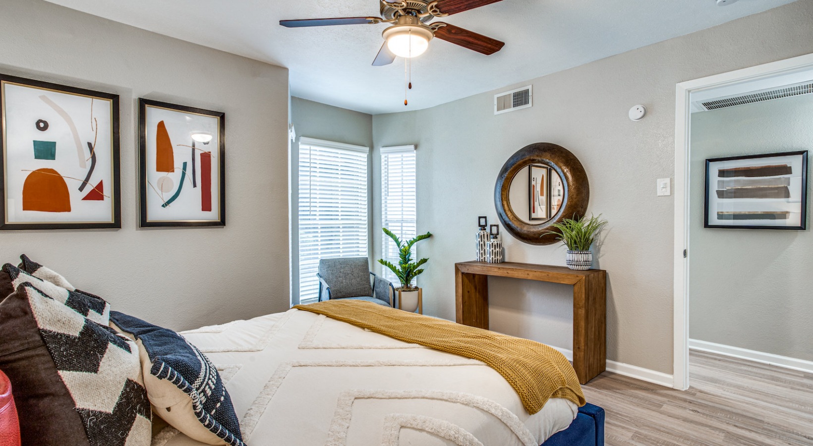 a bedroom with a bed, dresser and ceiling fan at The Richmond