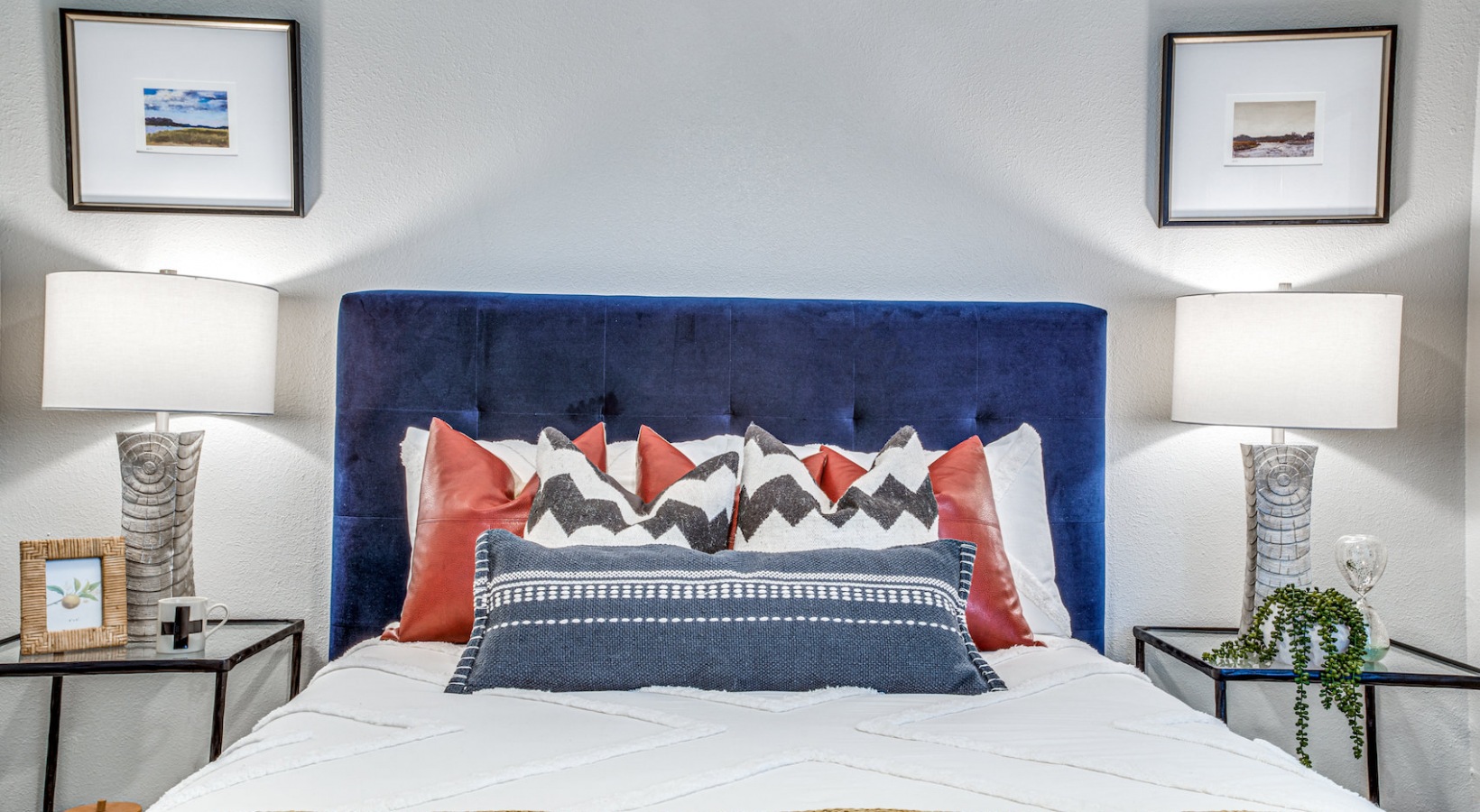 a bed with a blue headboard and a white bedspread at The Richmond