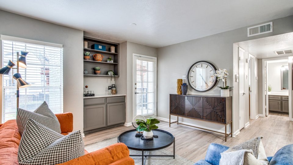 a living room with a couch, coffee table and a clock at The Richmond