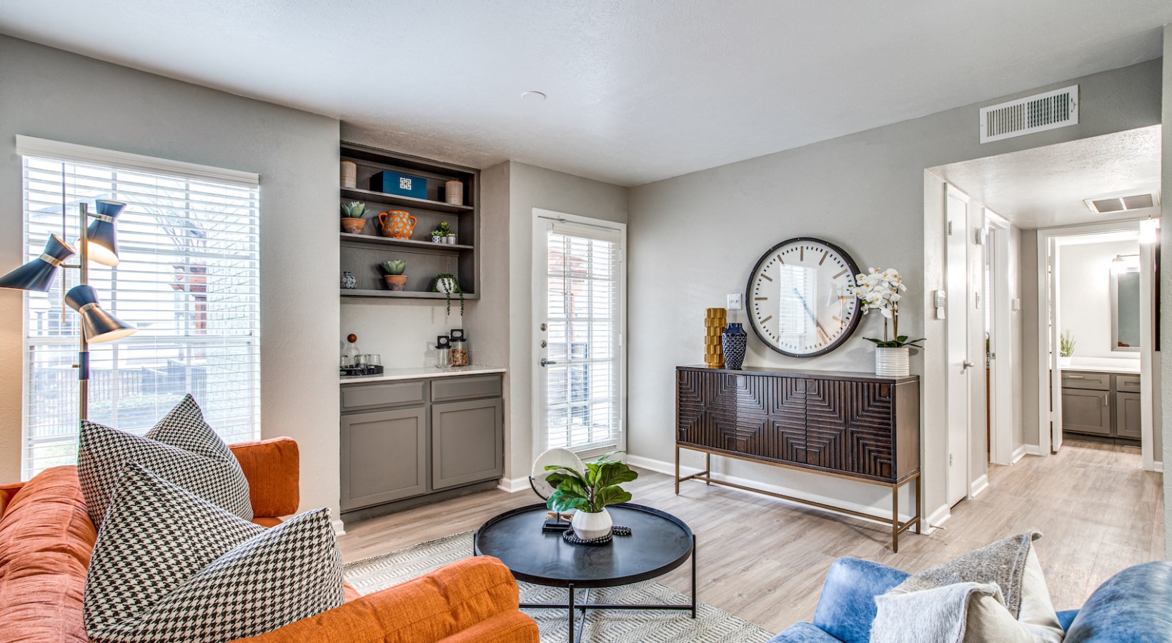 a living room with a couch, coffee table and a clock at The Richmond
