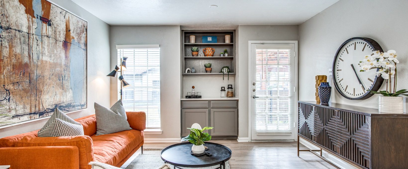 a living room with a couch, coffee table and a clock at The Richmond