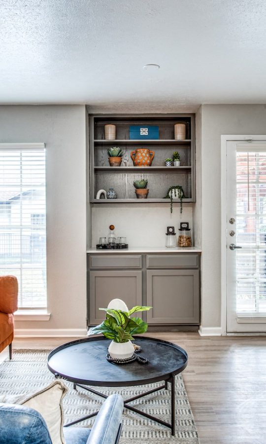 a living room with a couch, coffee table and a clock at The Richmond