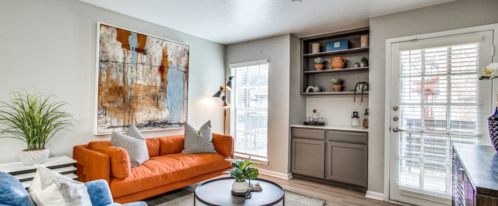 a living room with a couch, coffee table and a painting at The Richmond