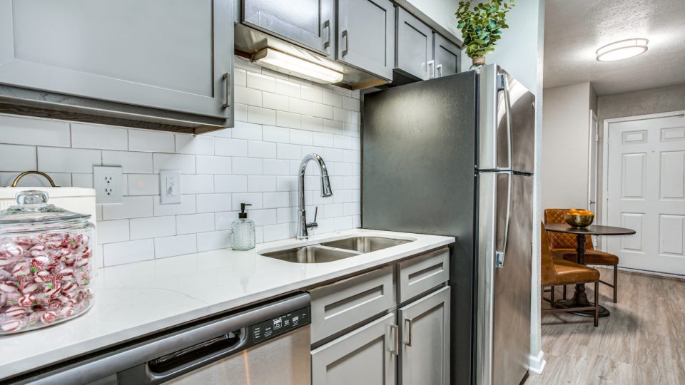 a kitchen with stainless steel appliances and a sink at The Richmond