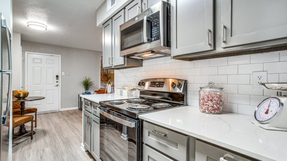 a kitchen with stainless steel appliances and a microwave at The Richmond