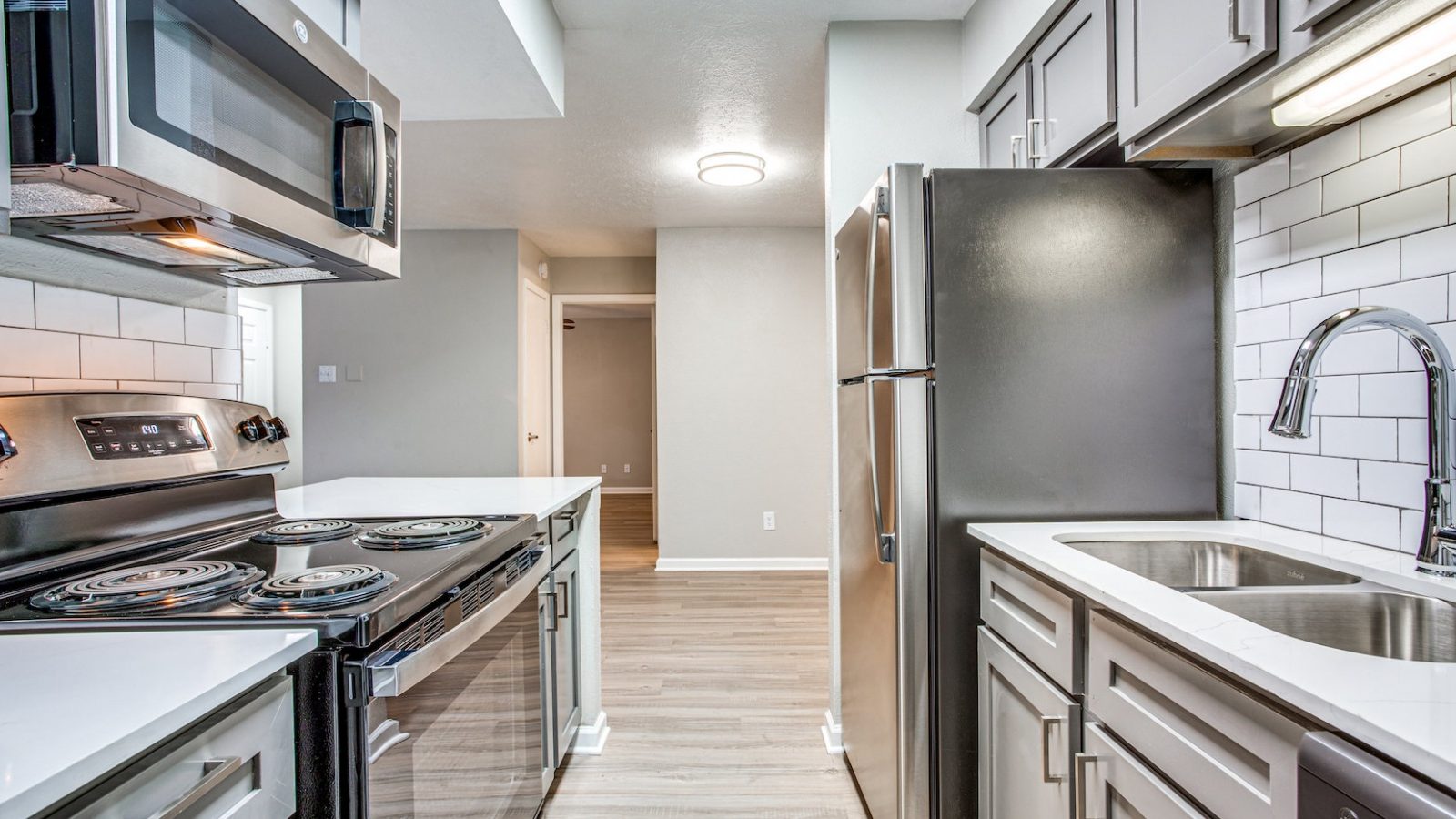 a kitchen with stainless steel appliances and a sink at The Richmond
