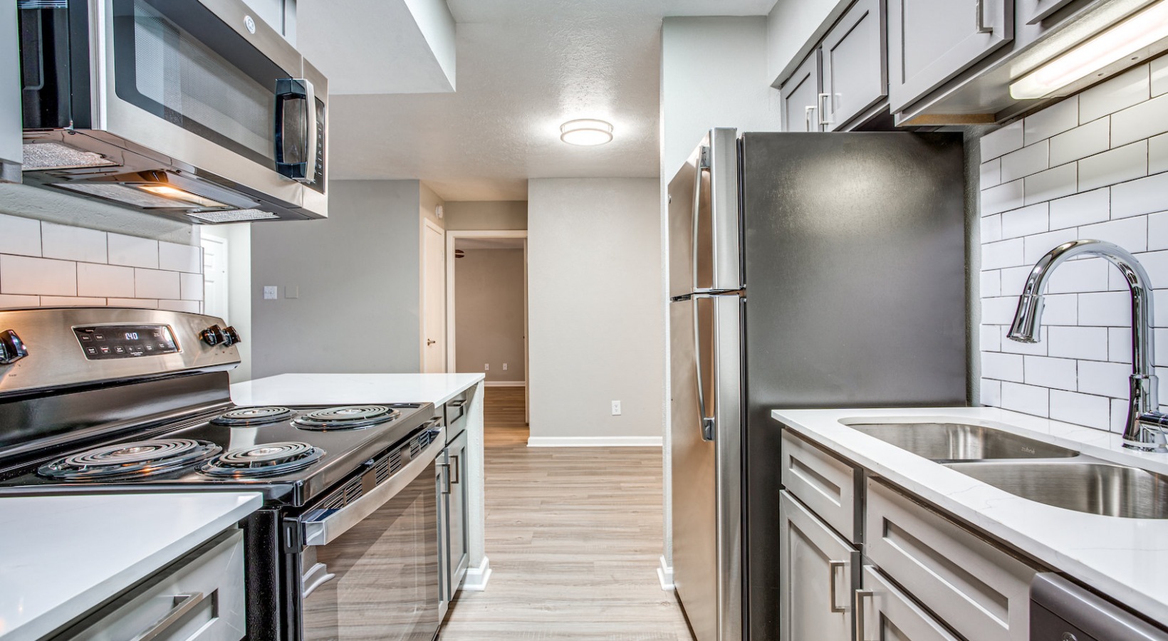 a kitchen with stainless steel appliances and a sink at The Richmond